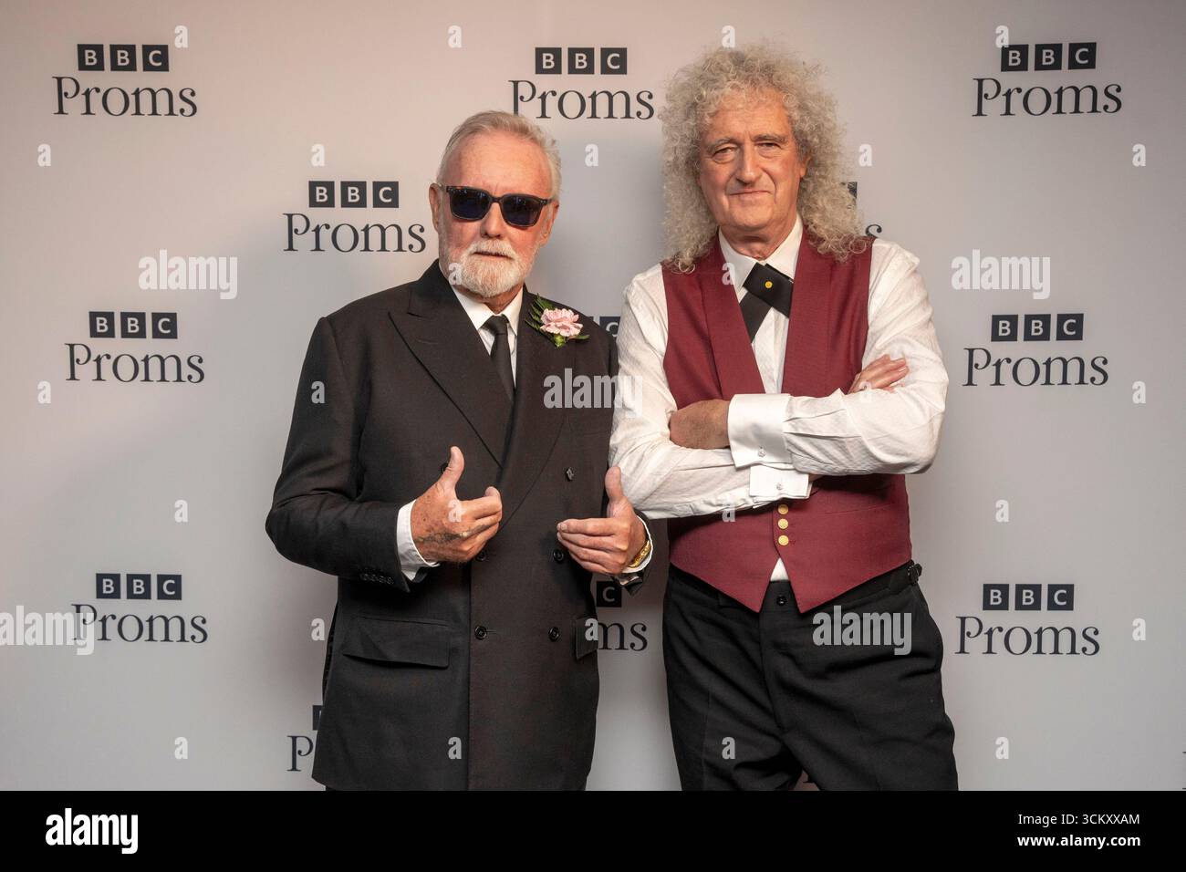 Roger Taylor Left And Sir Brian May From Queen Pose Backstage At The