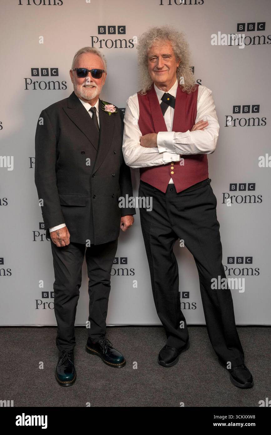 Roger Taylor Left And Sir Brian May From Queen Pose Backstage At The