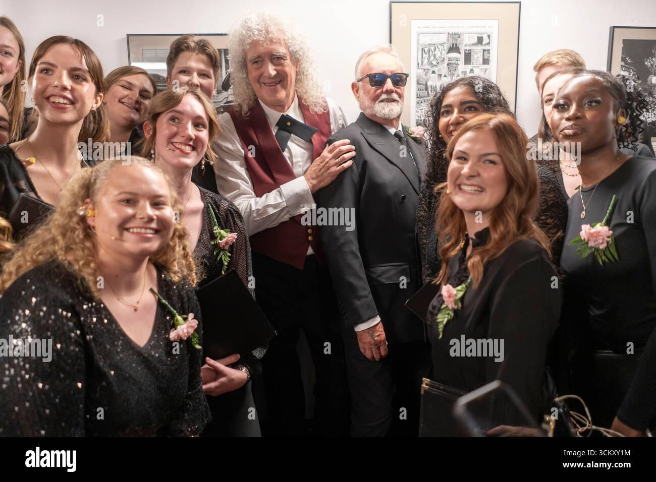 Roger Taylor Left And Sir Brian May From Queen Pose Backstage At The