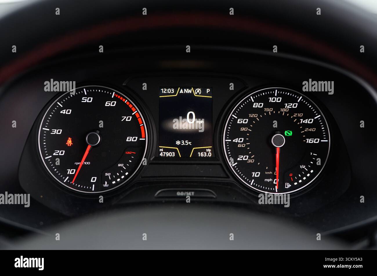 car instrument cluster featuring a speedometer and tachometer ...