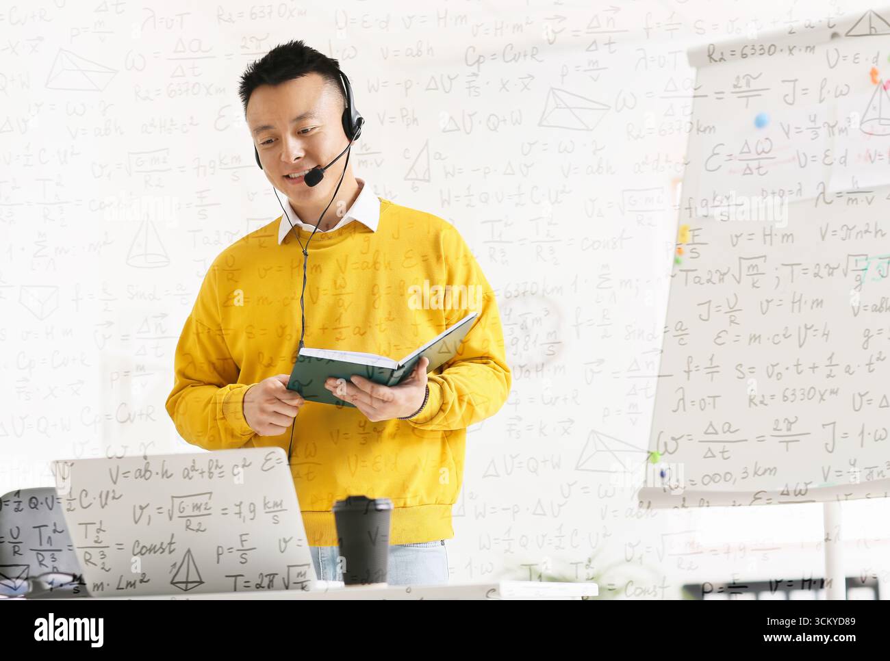 Asian teacher conducting lesson online Stock Photo