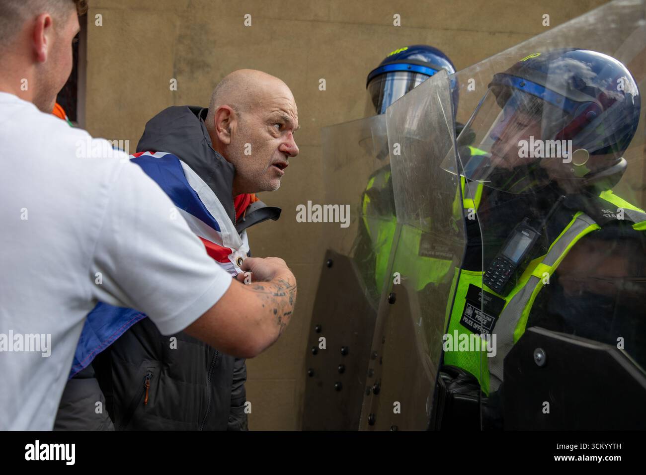 Metropolitan Police riot officers clash with a protestor during a ...