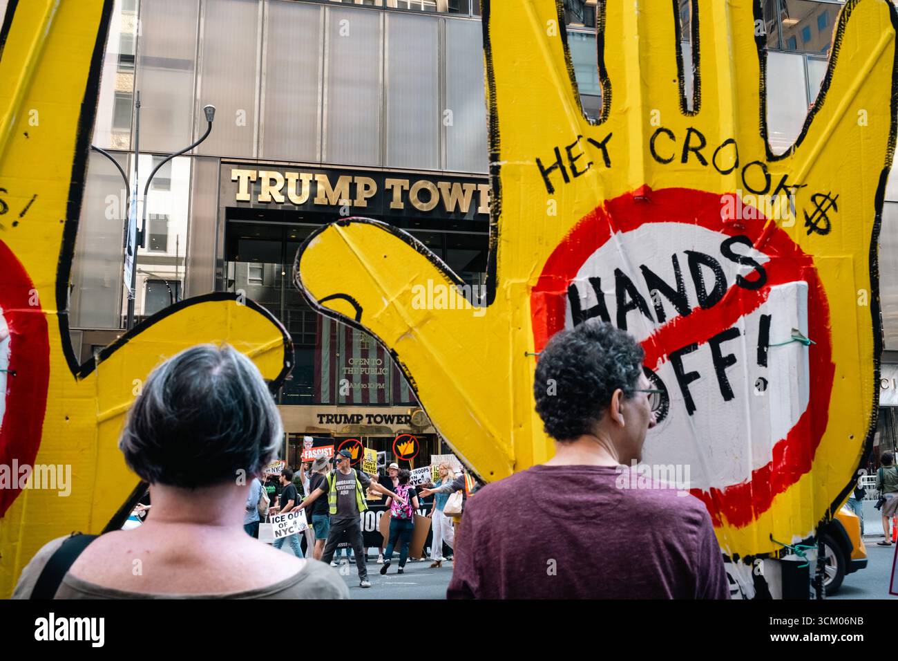 Protesters gather in front of Trump Tower holding signs that read 