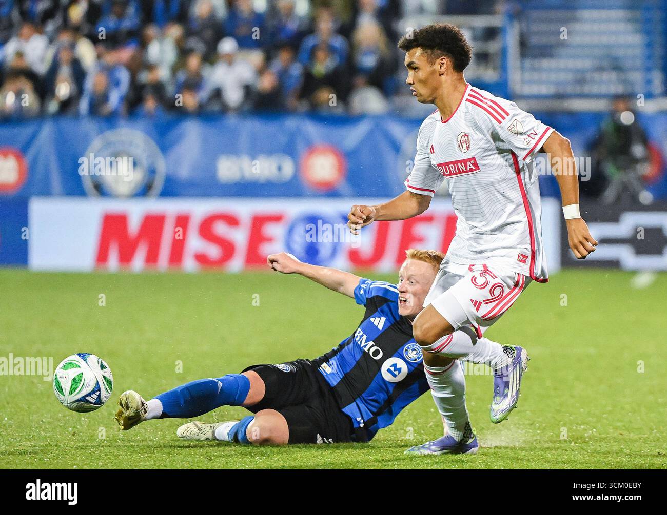 CF Montreal's Matty Longstaff, bottom, slides in on St. Louis City's