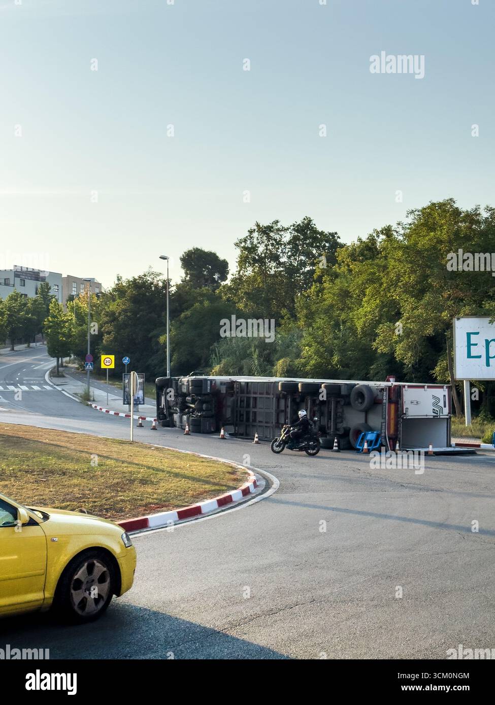 Rubi, Barcelona, Spain. August 9, 2025. An overturned truck causes a traffic jam on a suburban road. The accident illustrates transportation problems - Smartphone Captured Stock Image