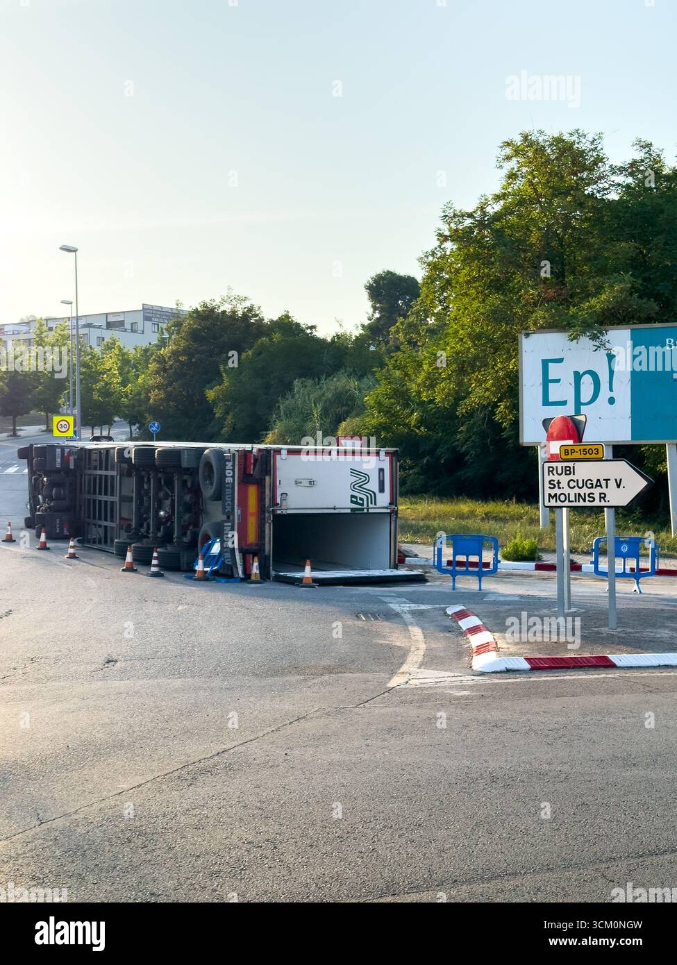 Rubi, Barcelona, Spain. August 9, 2025. An overturned truck causes a traffic jam on a suburban road. The accident illustrates transportation problems - Smartphone Captured Stock Image