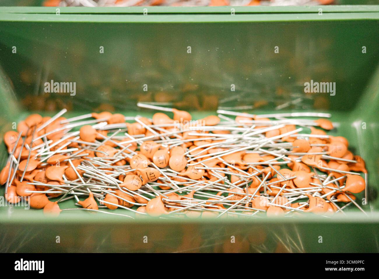 Ceramic capacitors stored in a green container for electronic components Stock Photo