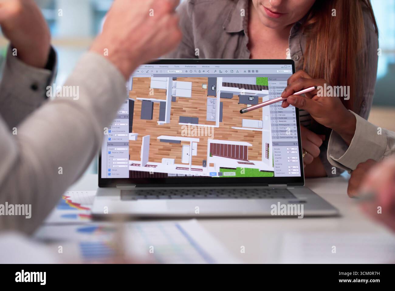 Multiracial Team Using CAD Software To Design Modern Estate Property. Stock Photo