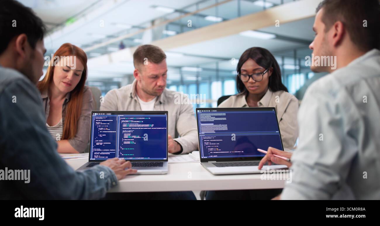 Young African American Software Engineer Typing Code On Laptop Screen. Stock Photo