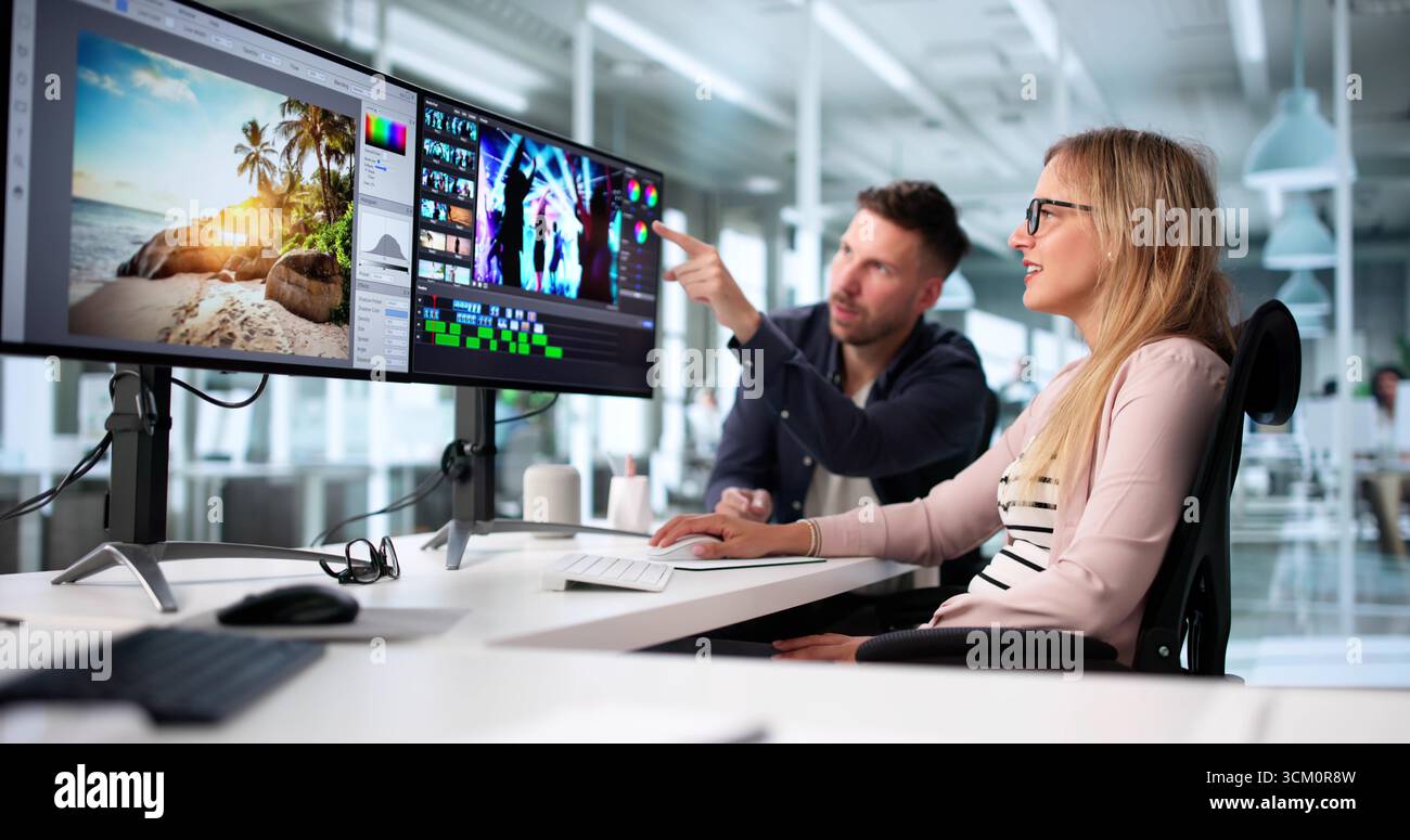 Two Graphic Designers Edit Web Ads In Collaboration Project Together. Stock Photo