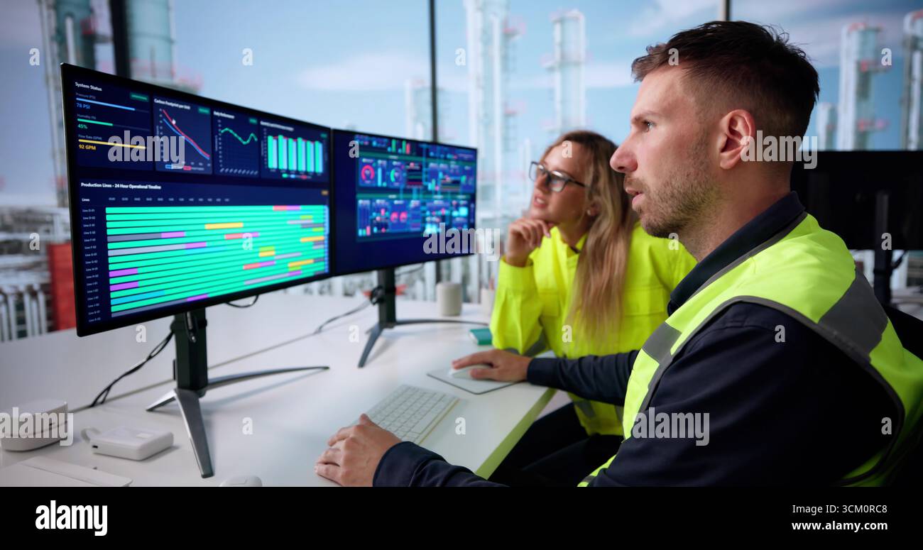 Engineer Operating An Industrial Data Automation System On A Computer. Stock Photo