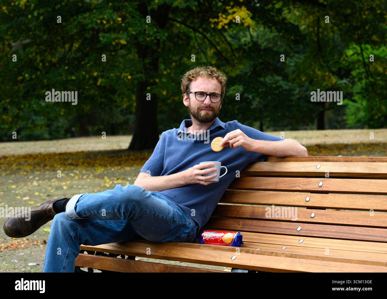 EMBARGOED TO 0001 MONDAY SEPTEMBER 15 EDITORIAL USE ONLY Documentary film maker 'A Mug of Life', real name William Shears, known on social media for his candid chats with strangers over tea on a bench, sits in Hyde Park, London, as he partners with McVitie's and Mind to encourage small but meaningful connections over tea and biscuits, following research that shows that more than two-fifths of people in the UK feel lonelier than five years ago. Issue date: Monday September 15, 2025. Stock Photo