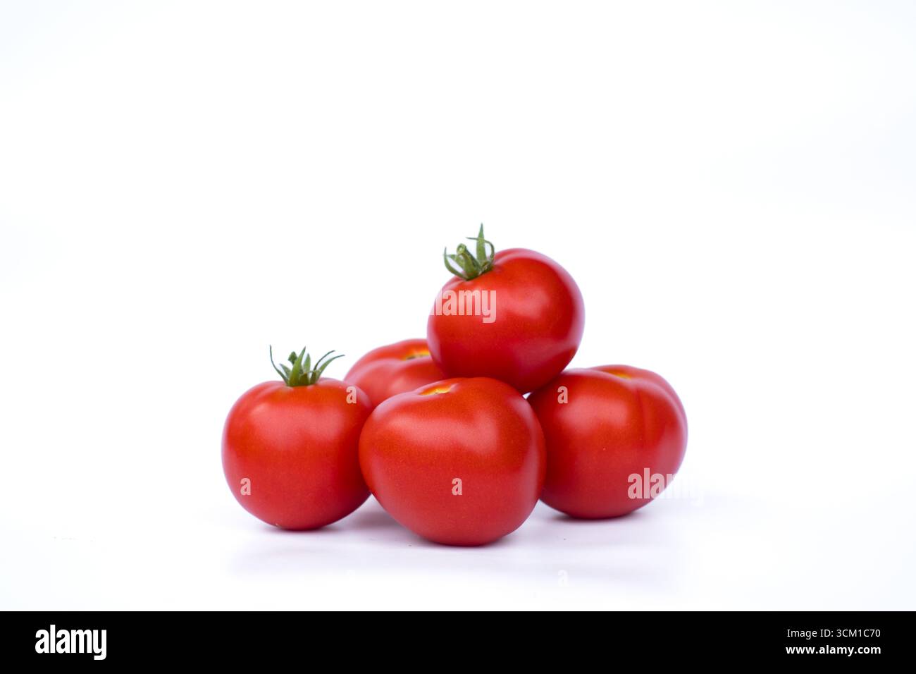 Red ripe tomatoes isolated on white background. Freshness, nutrition, and healthy eating. Stock Photo