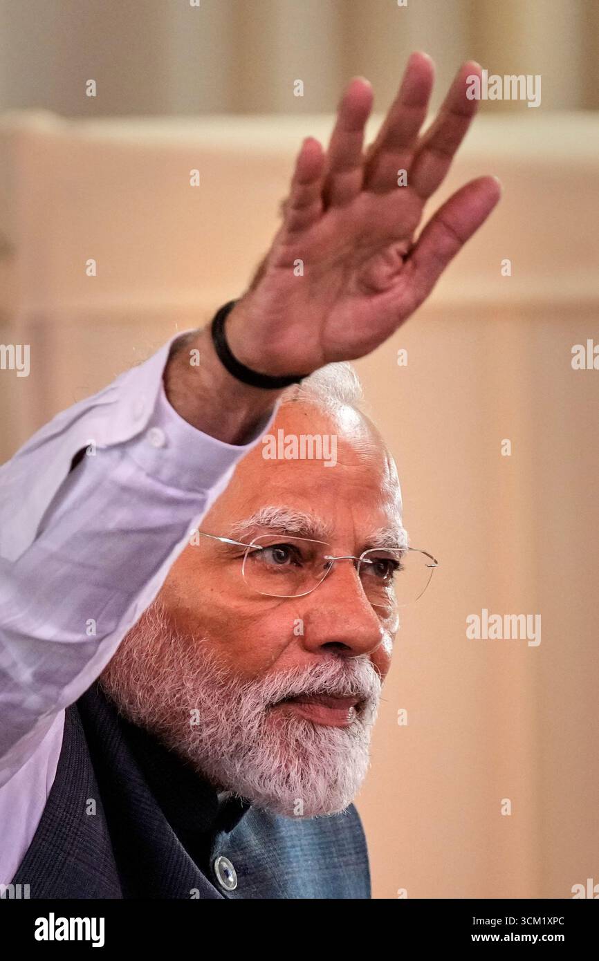 Indian Prime Minister Narendra Modi waves to his supporters during a ...