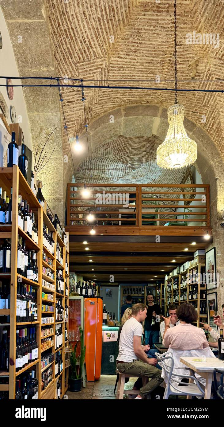 Diners in a traditional enoteca or wine bar in Alfama Lisbon Portugal - Smartphone Captured Stock Image
