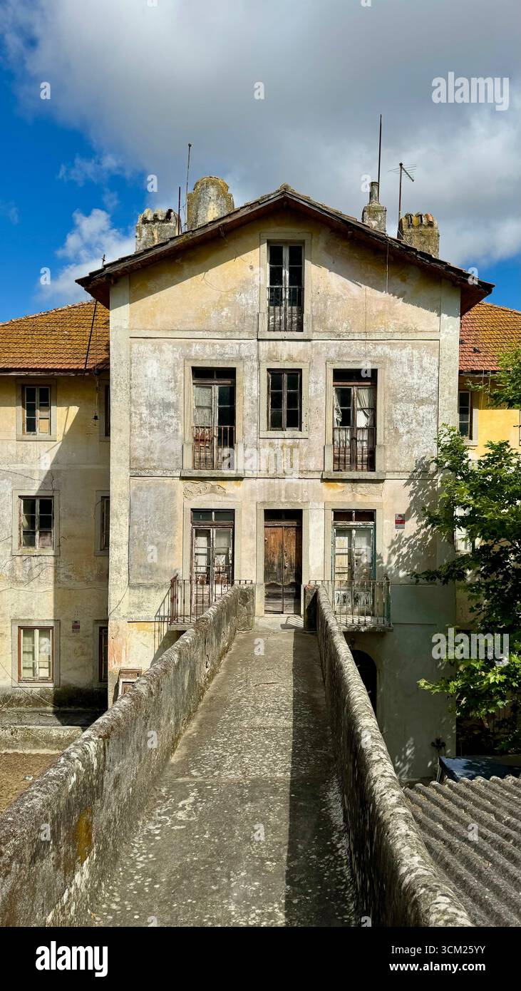 Abandoned dilapidated empty building with a footbridge in historical centre of Sintra Portugal - Smartphone Captured Stock Image