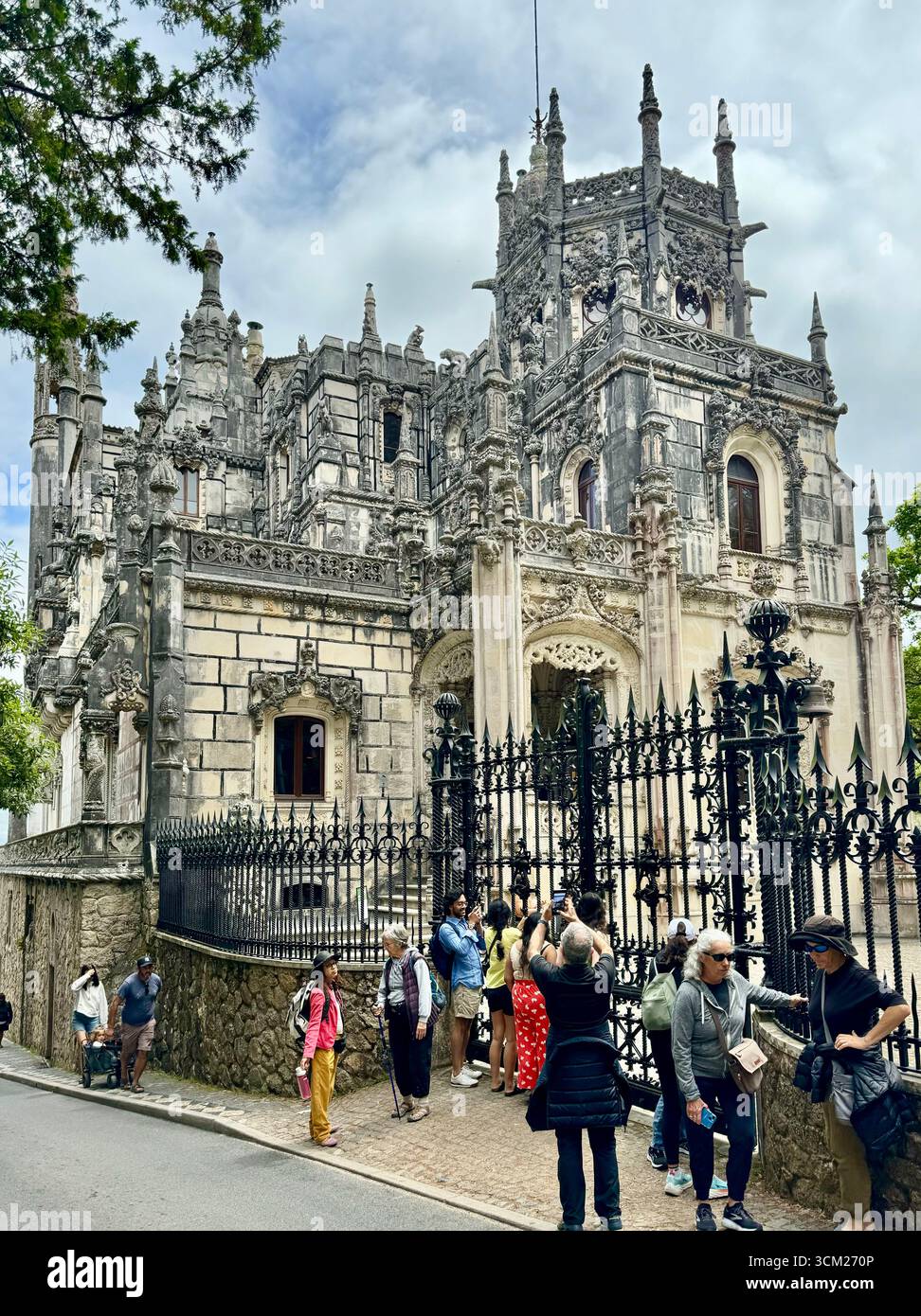 Tourists outside gate of Quinta da Regaleira manor house in World Heritage Site of Sintra Portugal - Smartphone Captured Stock Image