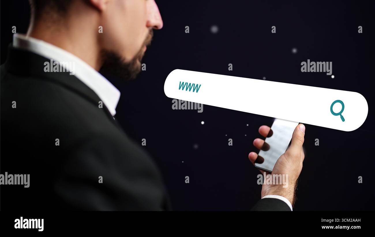 Man holding a phone with a search bar against a dark background, exploring the digital world and online resources Stock Photo