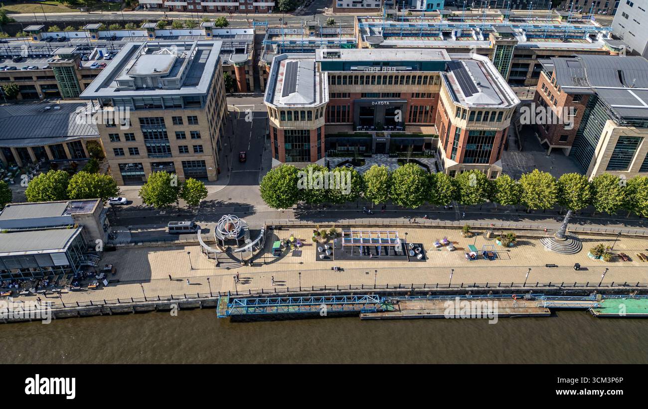 Aerial view of a modern cityscape with a river, buildings, a waterfront ...