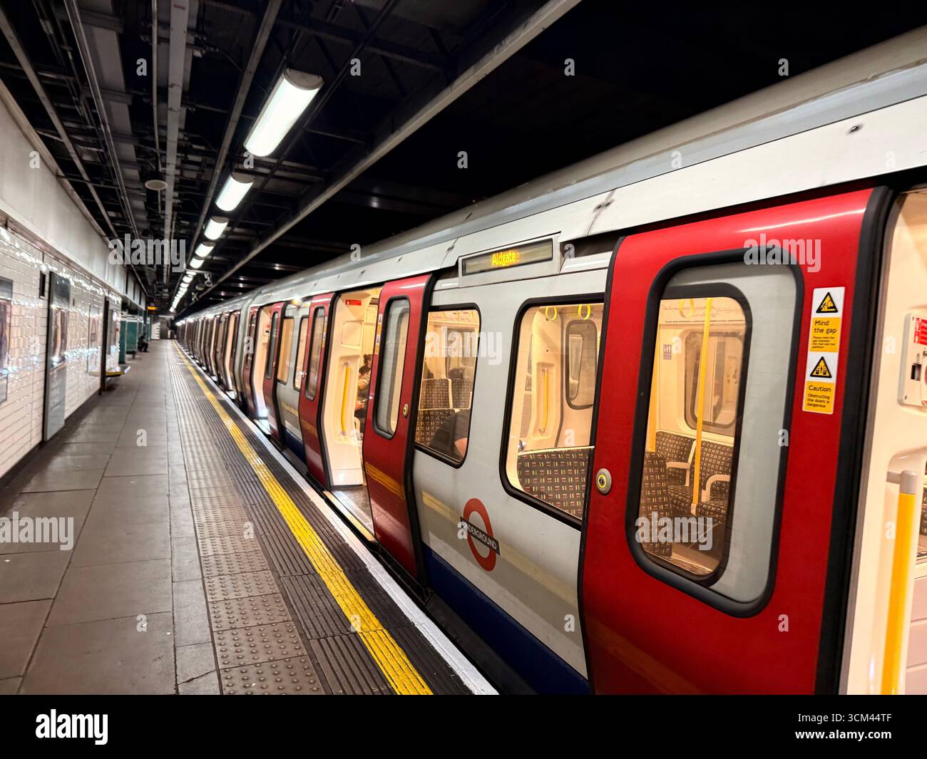 Tube train on deserted platform with open doors at Moorgate Station, London - Smartphone Captured Stock Image