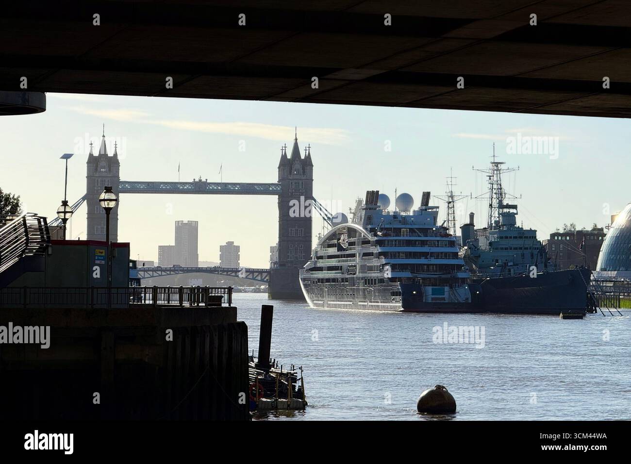 Cruise liner on river Thames moored by Tower Bridge and HMS Belfast framed by London Bridge - Smartphone Captured Stock Image