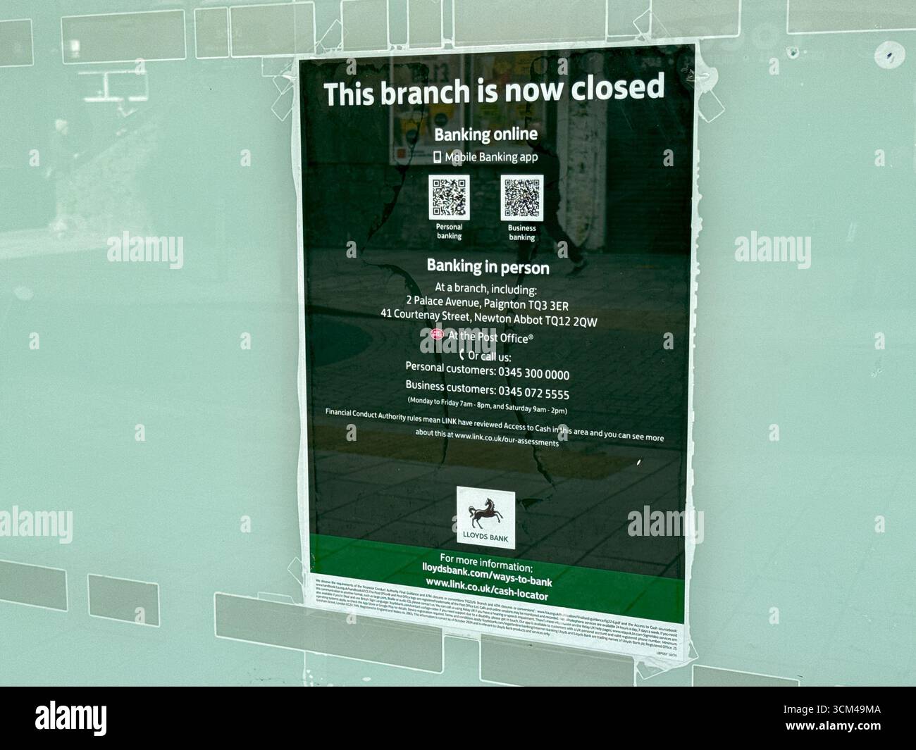 Torquay, Devon, England, UK - 23 April 2025: Close up view of a sign on the window of the branch of Lloyds Bank in the town centre which closed - Smartphone Captured Stock Image