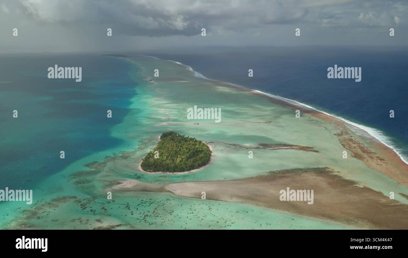 Aerial view of Fakarava Atoll in French Polynesia, featuring a lush ...