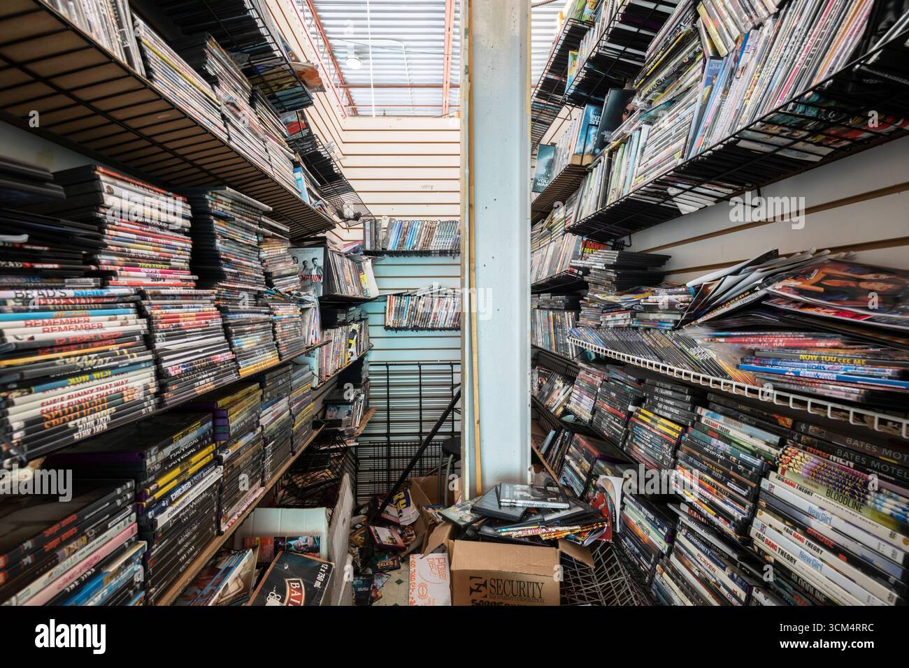 Racks of bootleg DVDs inside a closet at an abandoned flea market. This building has since been demolished. Stock Photo
