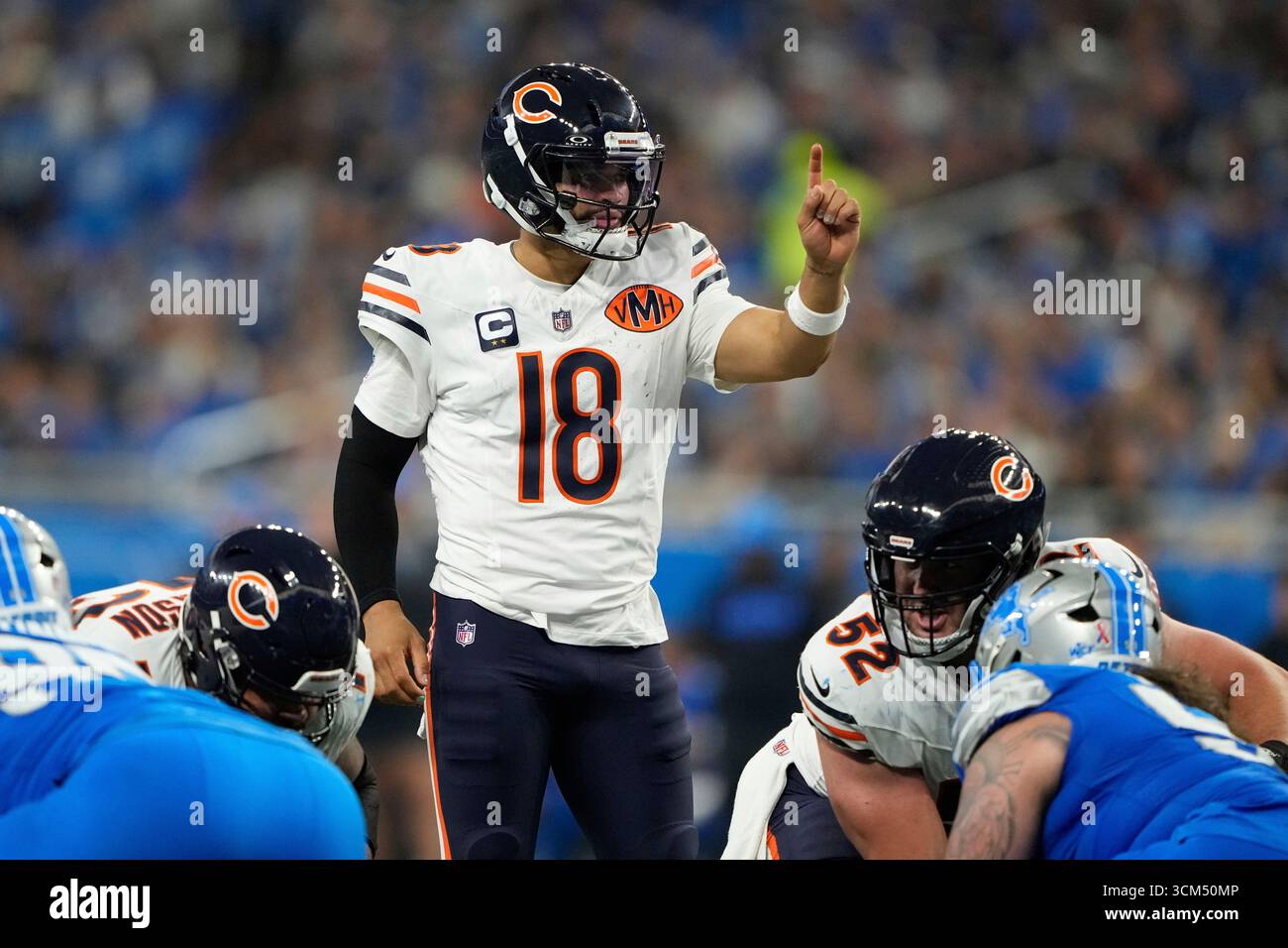 Chicago Bears quarterback Caleb Williams (18) signals during the first