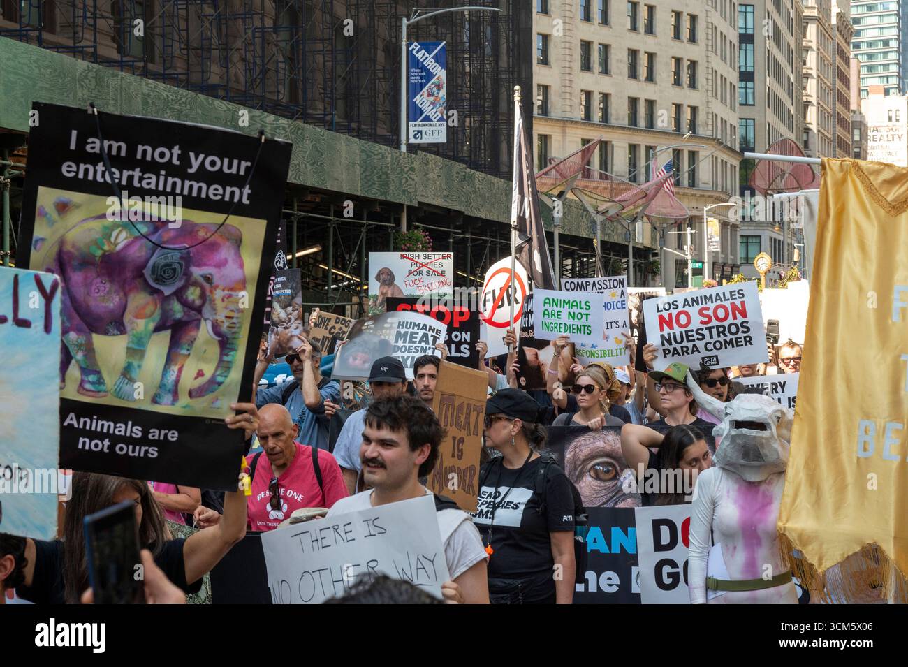 Hundreds of animal rights protesters with placards participate in the ...