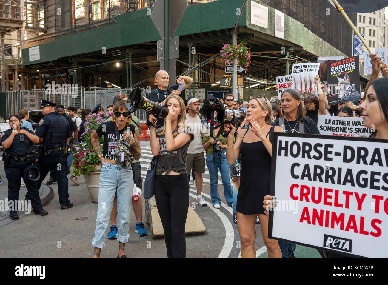 Hundreds of animal rights protesters with placards participate in the ...