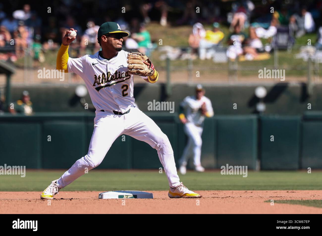Athletics third baseman Darell Hernaiz turns a double play during the ...