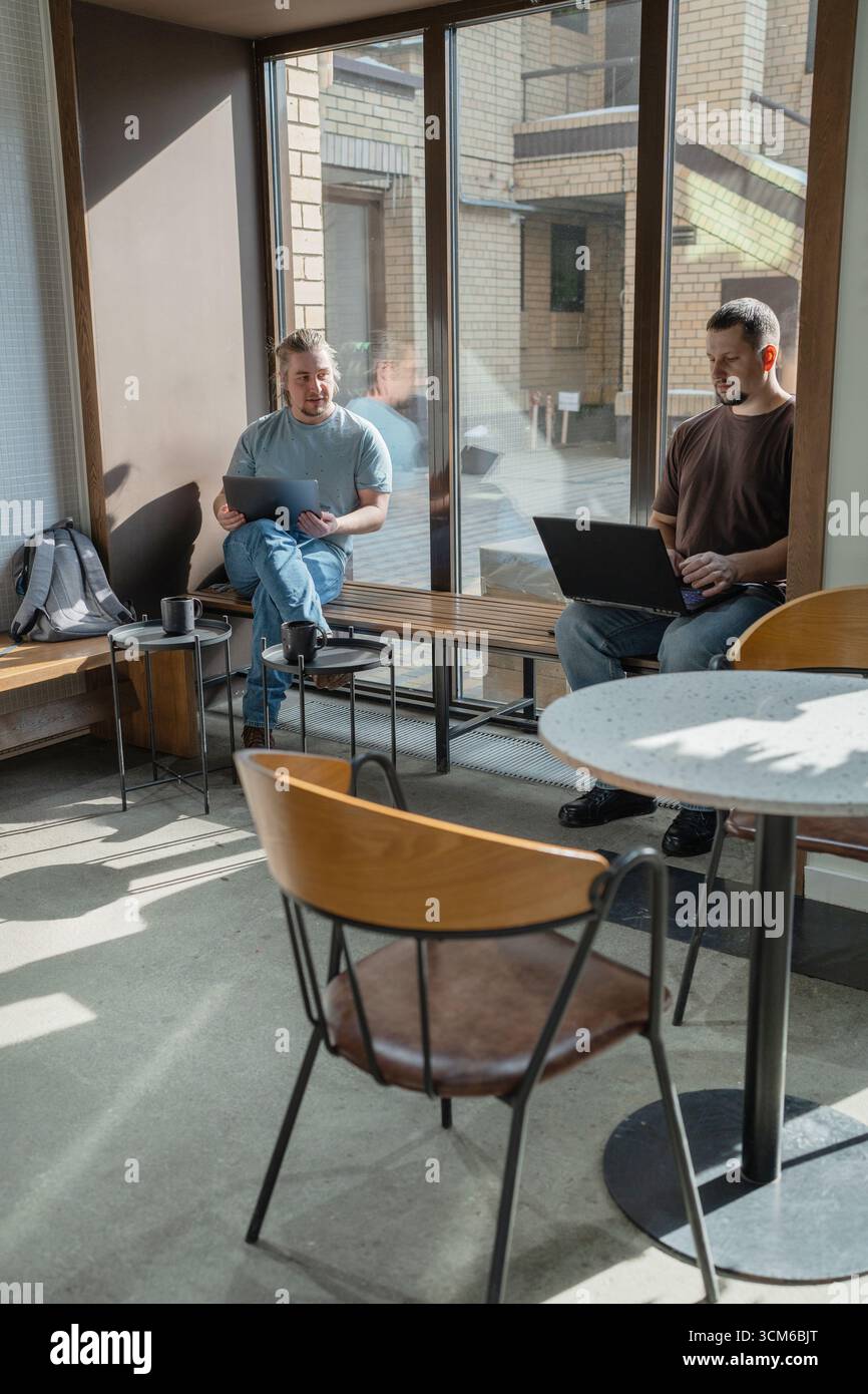 Two knowledgeable professionals collaborating effectively together in a modern workspace setting Stock Photo