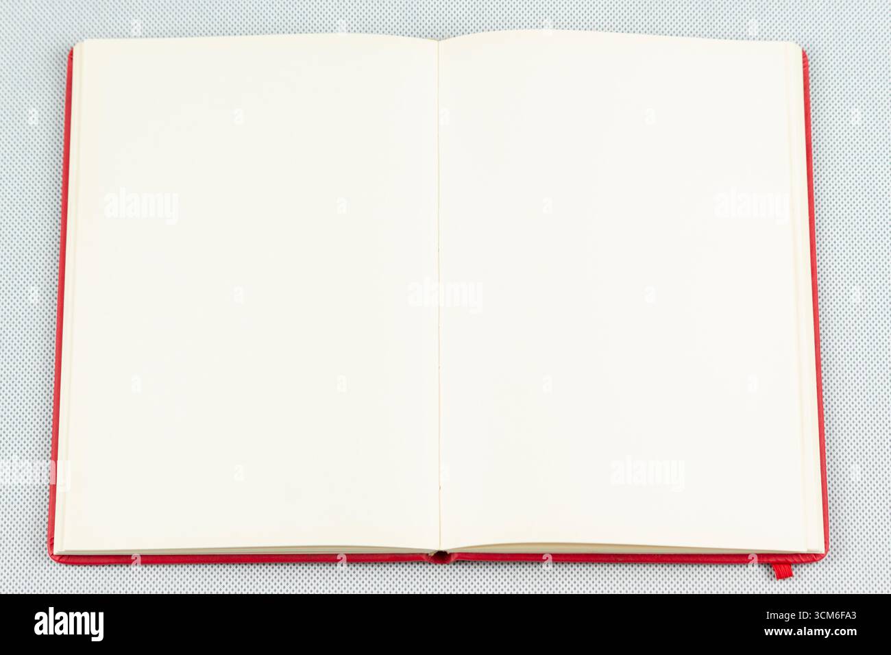 close up to a red blanked notebook over a white background Stock Photo
