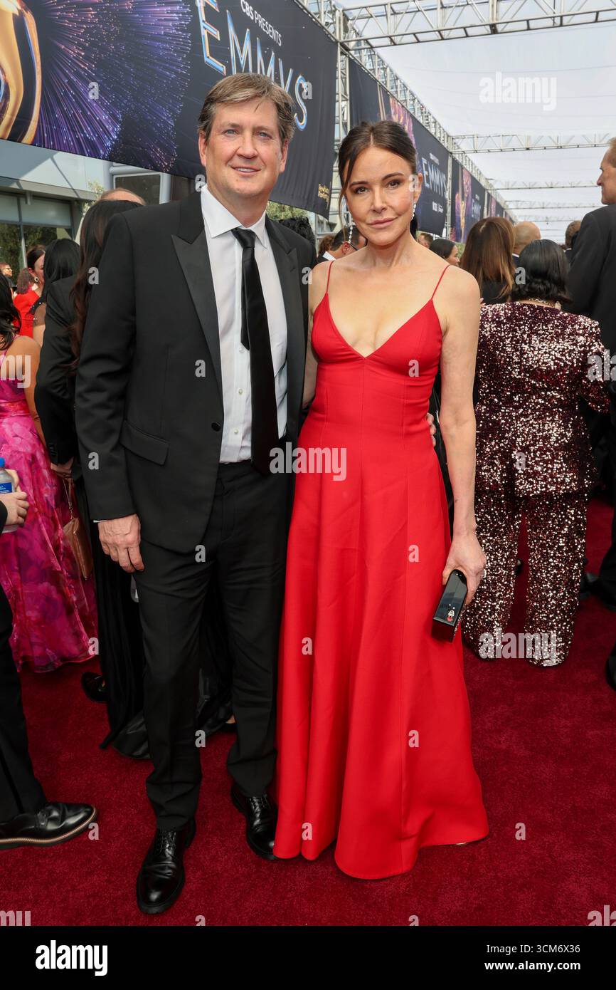 Bill Lawrence and Christa Miller walks the red carpet at the 77th Emmy ...
