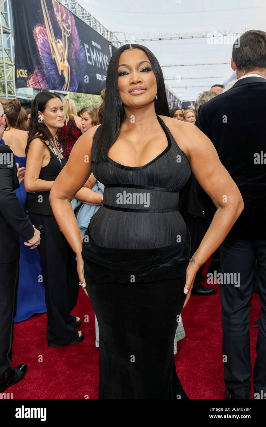 Garcelle Beauvais walks the red carpet at the 77th Emmy Awards on ...