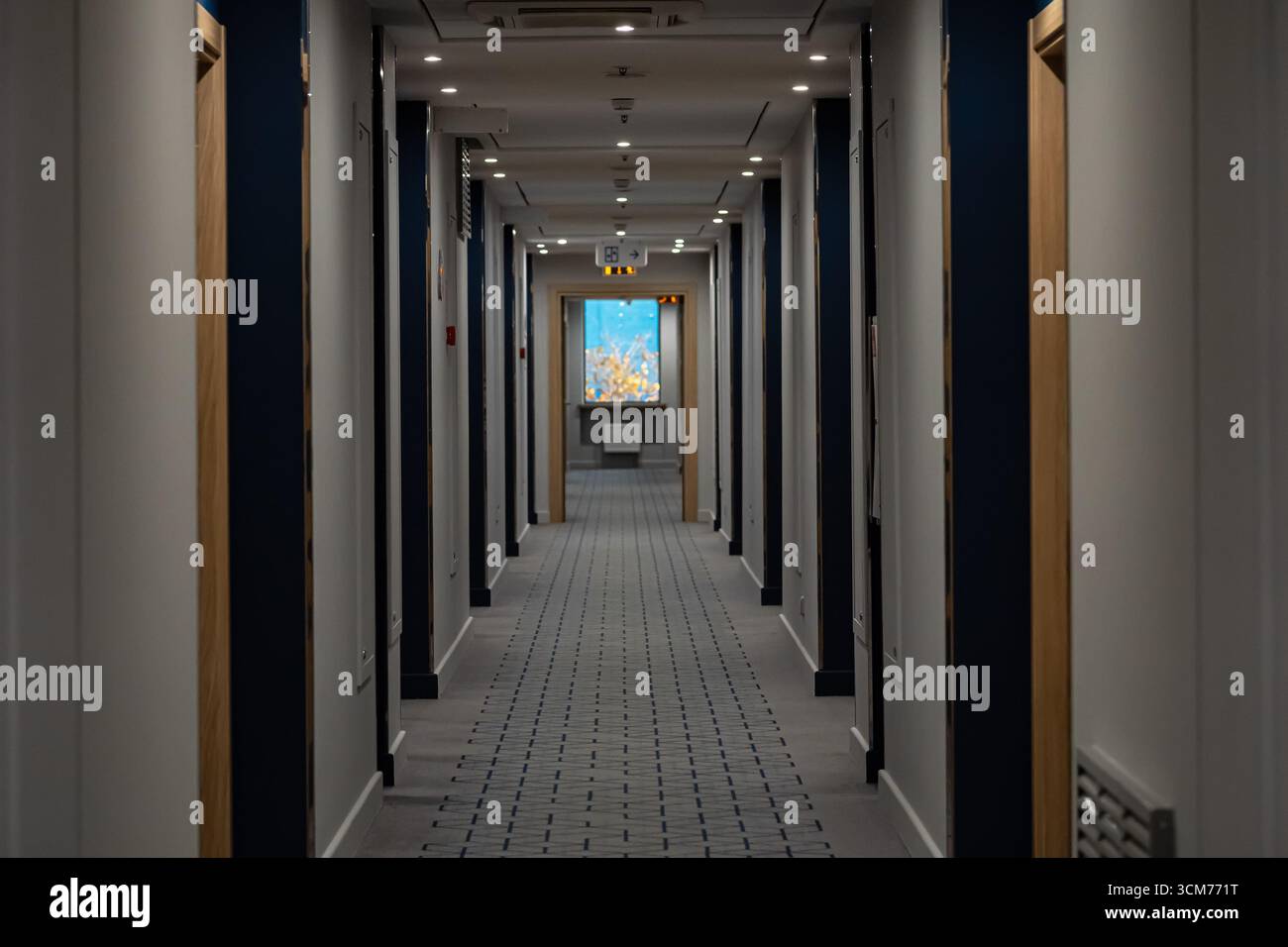 Long corridor with many doors in modern hotel Stock Photo