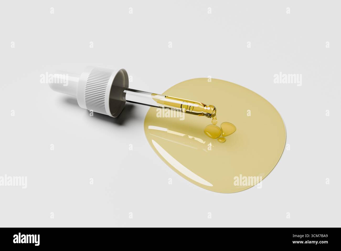 dropper filled with a golden liquid rests beside two drops of oil on a ...