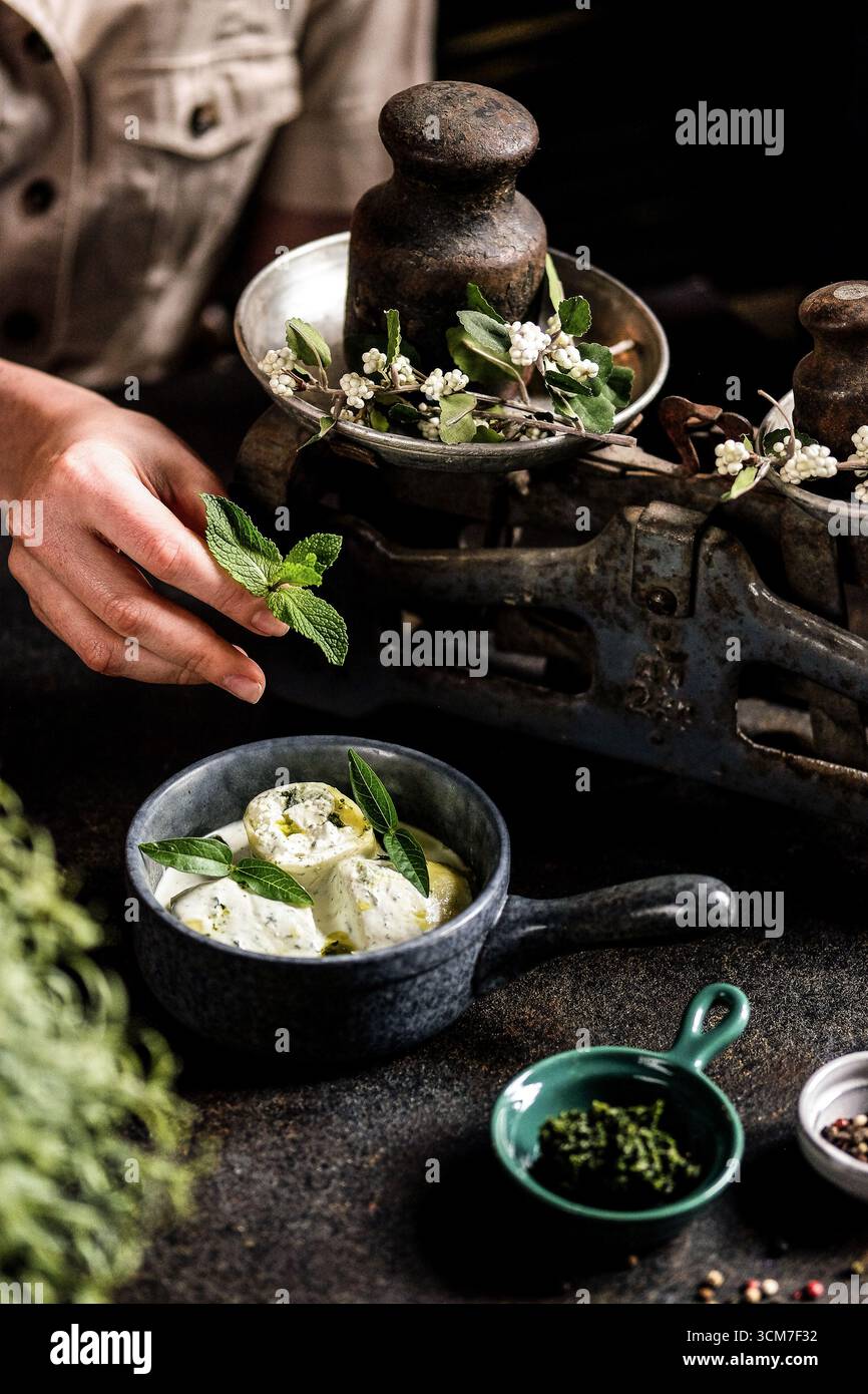 Explore the world of fresh herbs and delightful culinary creations in a charming rustic setting Stock Photo