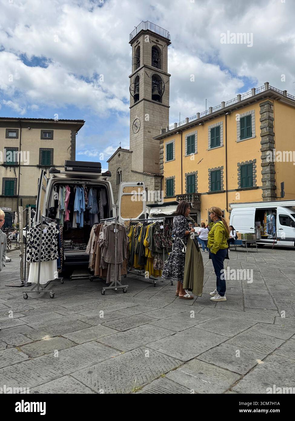 A Ladies fashion stall with a van at the weekly market held in front of the Chiesa del S. Jacopo e Antonio (Church of S. and Antonio on the 16th centu - Smartphone Captured Stock Image