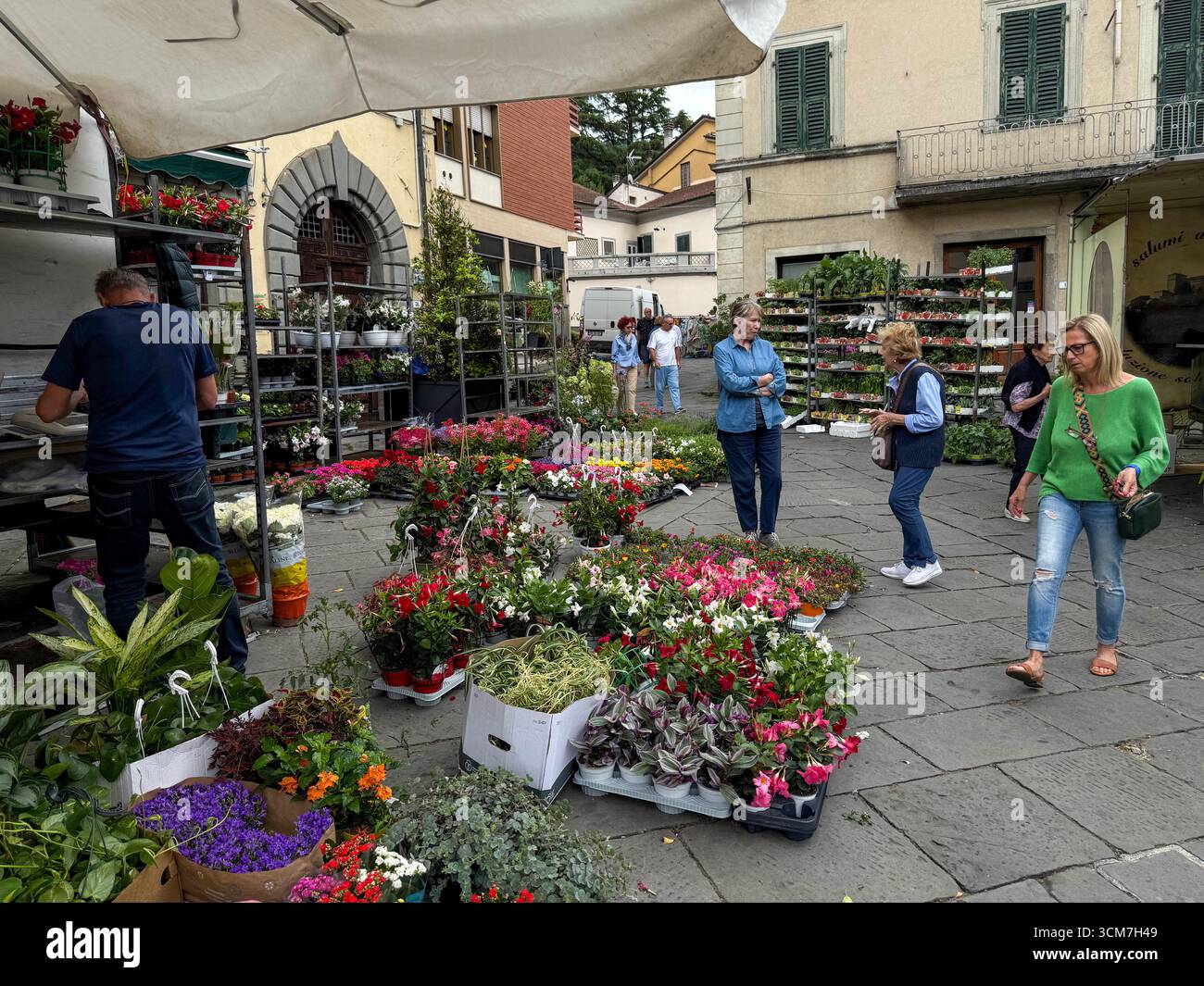 At the weekly market held on the 16th century Piazza Medice) in the medieval town of Fivizzano, a commune in the province of Massa and Carrara in the - Smartphone Captured Stock Image