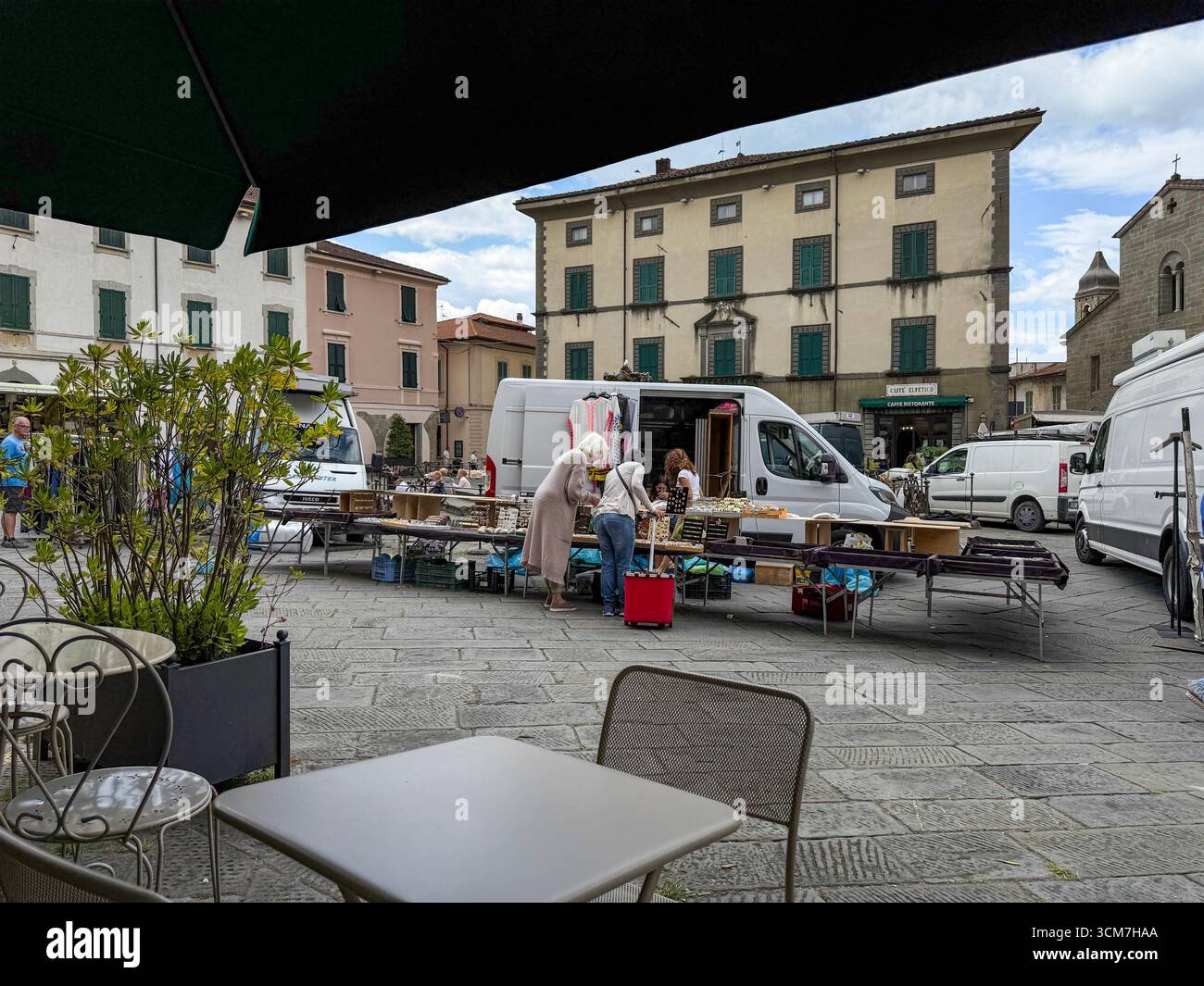 The weekly market day is held in front of the Chiesa del S. Jacopo e Antonio (Church of S. and Antonio on the 16th century Piazza Medice)  in the medi - Smartphone Captured Stock Image
