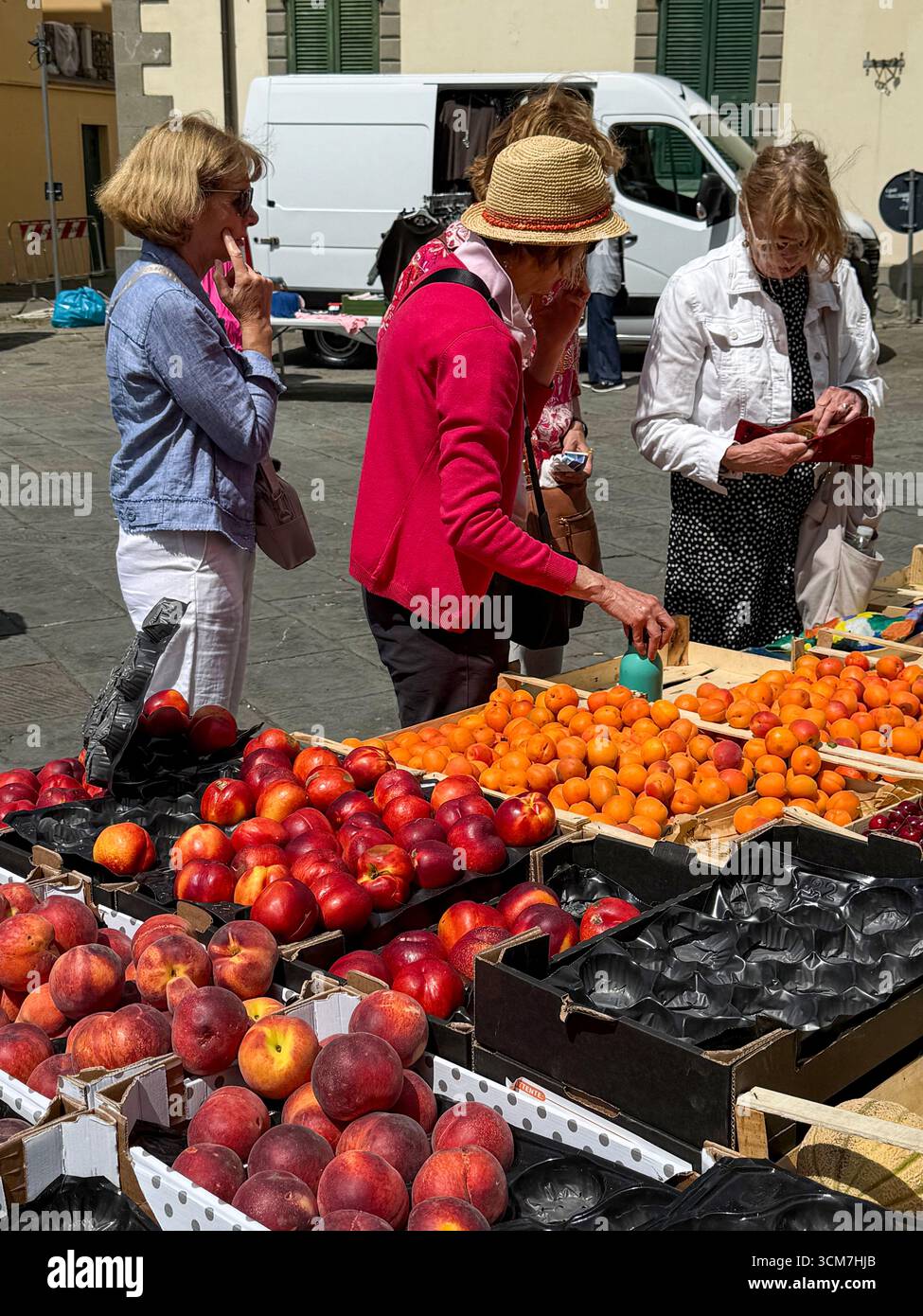 A busy fruit& veg stall at the weekly market held on the 16th century Piazza Medice) in the medieval town of Fivizzano, a commune in the province of M - Smartphone Captured Stock Image
