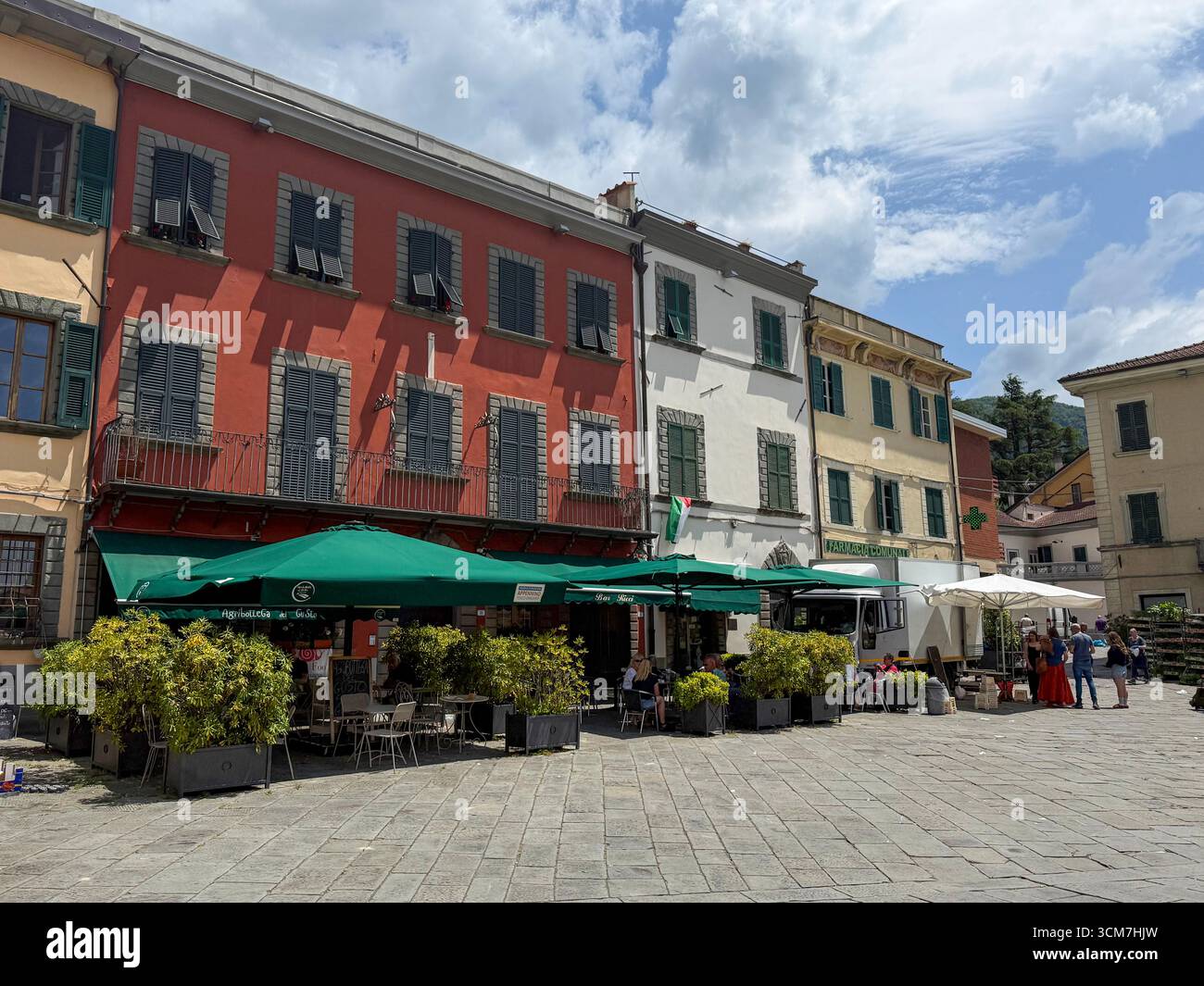 A row of shops and cafes on the 16th century Piazza Medice in the medieval town of Fivizzano, a commune in the province of Massa and Carrara in the n - Smartphone Captured Stock Image