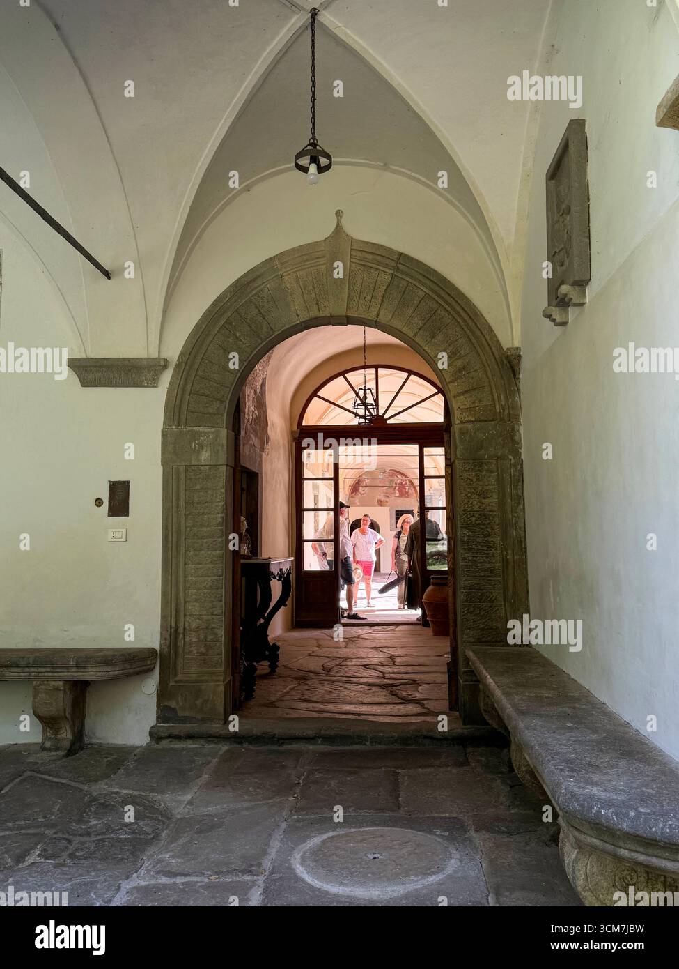 Through the main entrance leading into the central courtyard at the !6th century monastery called 11 convento del Carmine is near the small medieval t - Smartphone Captured Stock Image