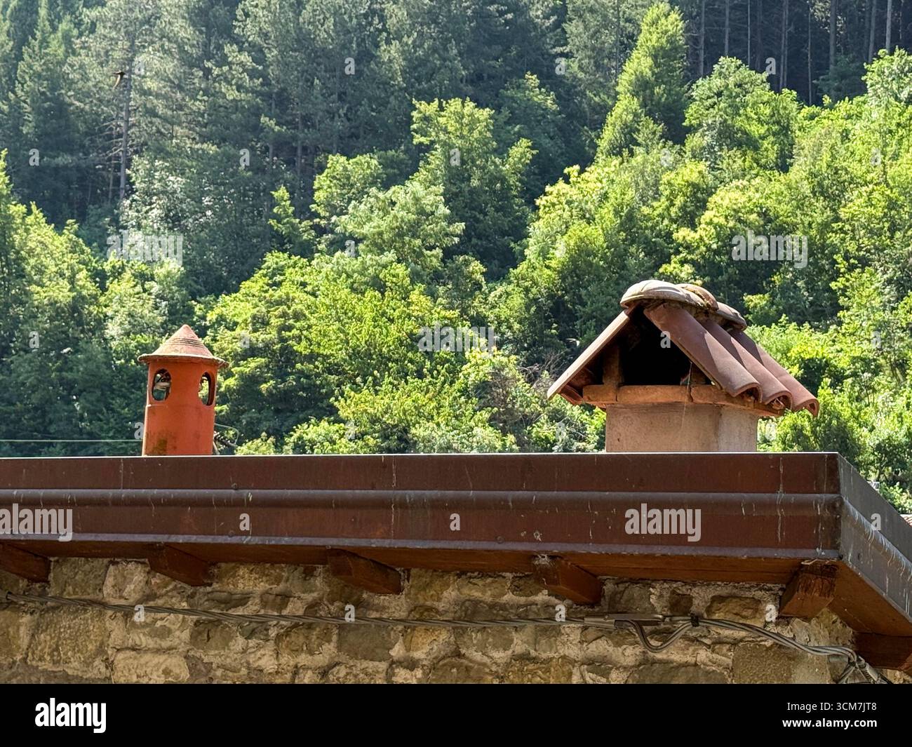 A pair of unusual chimney pots on a house at Castello della Verrucola (Verrucola castle), first documented in 1044. The castle is a couple of kilometr - Smartphone Captured Stock Image