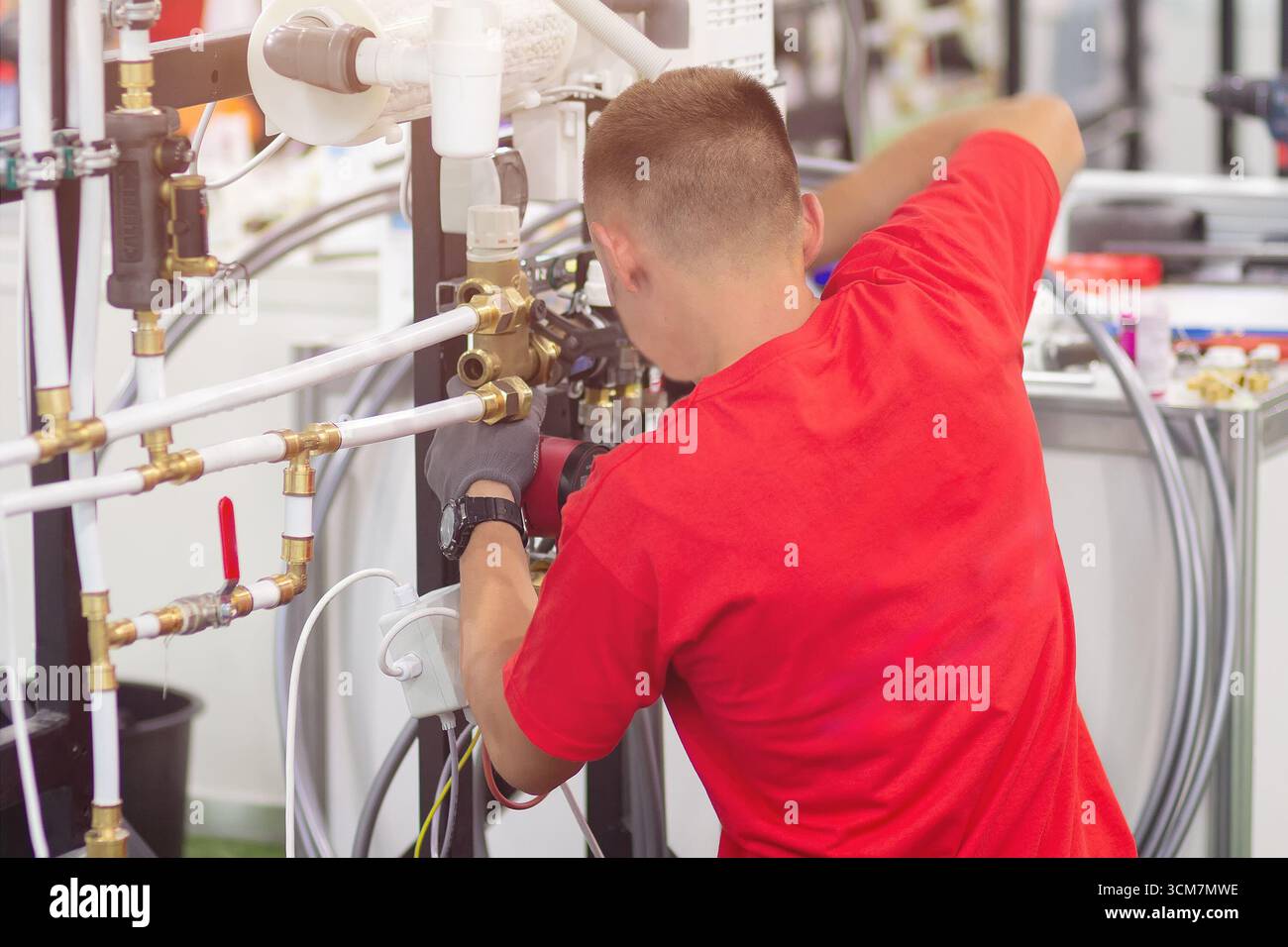 Installing collector for warm water underfloor heating system. Plumber work. Stock Photo