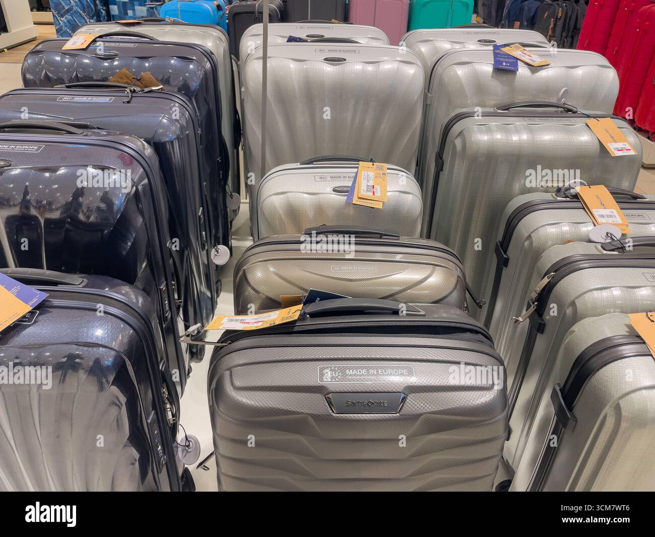 Germany Berlin 09.13.2025. A display of modern Samsonite suitcases in silver and gray tones. Hard-shell luggage with sale tags arranged neatly in a st Stock Photo