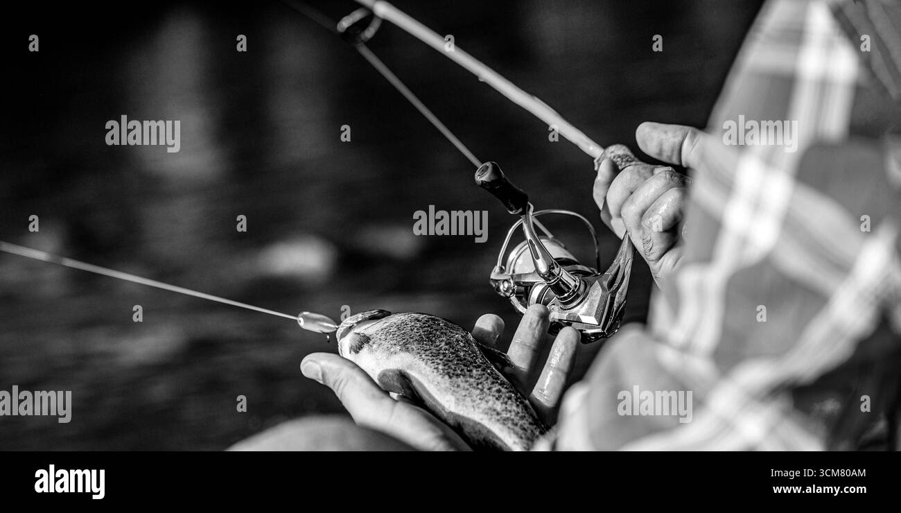 black and white trout with fishing pole Trout fly Black and White Stock Photos & Images