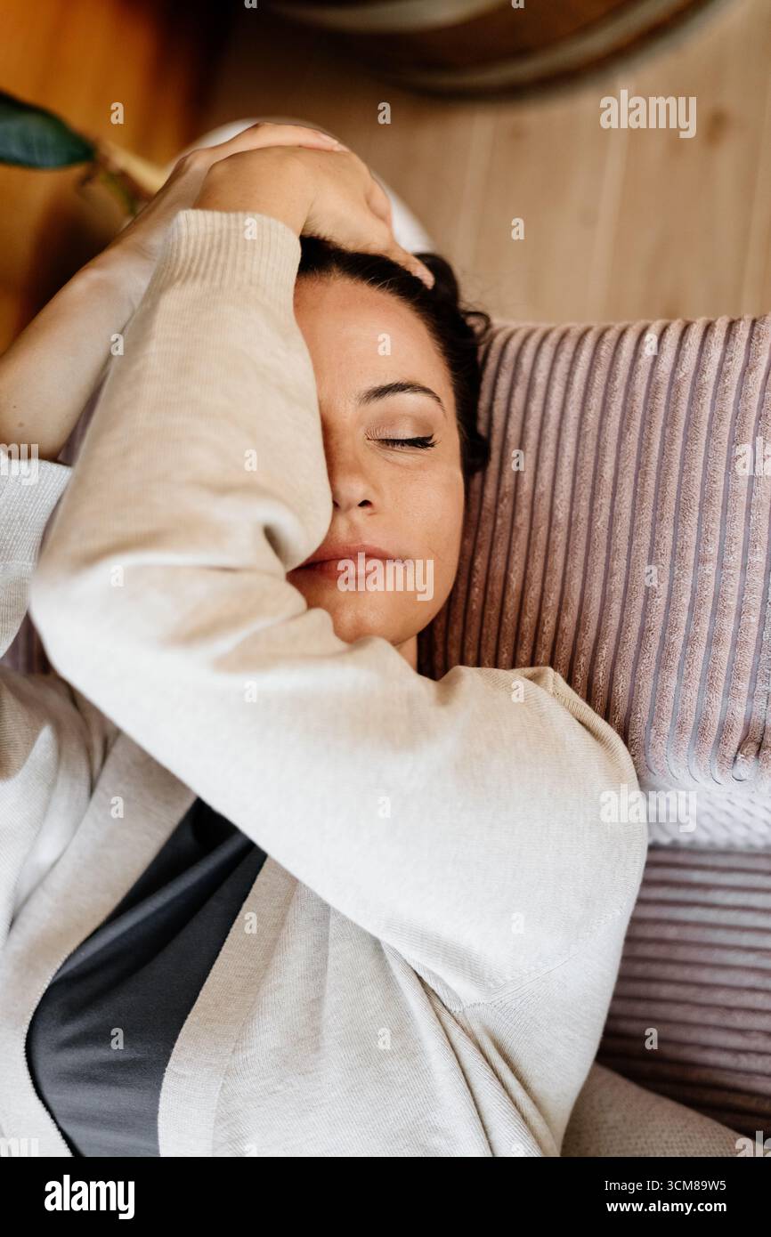 Relaxed woman taking a break, resting on sofa with closed eyes Stock ...